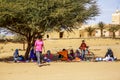 Berber vendors with tourists in a moroccan village at a traditional marketplace or souq Royalty Free Stock Photo