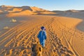 Berber walking with camel at Erg Chebbi, Morocco Royalty Free Stock Photo