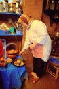 Berber woman preparing food in her kitchen