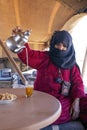 Berber woman preparing tea for guests at a camp in the Merzouge desert