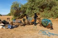 Berbers prepare camels for travel.