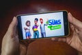 Berdyansk, Ukraine - March 4, 2019 - Close up of hand of person playing The Sims Mobile game apllication Royalty Free Stock Photo