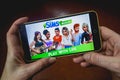 Berdyansk, Ukraine - March 4, 2019 - Close up of hand of person playing The Sims Mobile game apllication Royalty Free Stock Photo