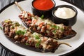 Berenjena Rellena Spanish Stuffed Eggplant with ground beef, vegetables and cheese close-up in a plate. Horizontal