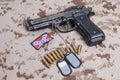 Beretta hand gun on desert marines uniform Royalty Free Stock Photo