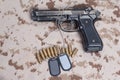 Beretta hand gun on desert uniform Royalty Free Stock Photo