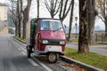 Traditional Italian three wheel car Piaggio Ape staying parked on the street