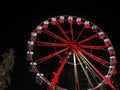 Bergamo, Italy. The Ferris wheel illuminated in red in the evening. Christmas time Royalty Free Stock Photo