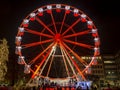 Bergamo, Italy. The Ferris wheel illuminated in red in the evening. Christmas time. Fun attraction Royalty Free Stock Photo