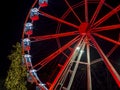 Bergamo, Italy. The Ferris wheel illuminated in red in the evening. Christmas time. Fun attraction Royalty Free Stock Photo