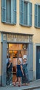 Bergamo/Italy - July 15, 2016: People smoking in front of a traditional italian restaurant Trattoria in a old building of