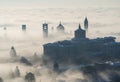 Bergamo, Italy. Lombardy. Amazing landscape of the fog rises from the plains and covers the old town Royalty Free Stock Photo