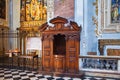 BERGAMO, ITALY - MAY 22, 2019: Old wooden confessional in the Catholic Church of Sant Agata nel Carmine in Bergamo Royalty Free Stock Photo