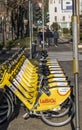 Bergamo, Italy. The new bike sharing system along the streets of the city. Group of yellow bikes ready to use