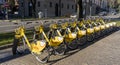 Bergamo, Italy. The new bike sharing system along the streets of the city. Group of yellow bikes ready to use