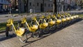 Bergamo, Italy. The new bike sharing system along the streets of the city. Group of yellow bikes ready to use