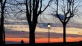 Bergamo, the old city. Lombardy, Italy. Silhouette of a person who admires the sunset towards the Po Valley from the ancient walls Royalty Free Stock Photo