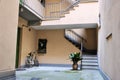 Bergamo old Italian town entrance residential building stairs bike beautiful interior green flower background