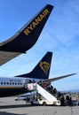 2019.09.30 Bergamo, Orio al Serio airport Ryanair plane in the foreground with passengers who board the plane in the back Royalty Free Stock Photo