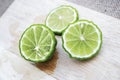 Bergamot fruit cutting slices on wooden clipping board on sackcloth background. Bergamot material of essential oils for beauty and