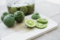 Bergamot fruit cutting slices on wooden clipping board on sackcloth background. Bergamot material of essential oils for beauty and