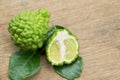 Bergamot fruit with green leafs on wood background Royalty Free Stock Photo