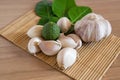 Bergamot and garlic on makisu mat on wood texture Royalty Free Stock Photo