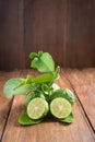 Bergamot with green leafs on wood background Royalty Free Stock Photo