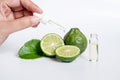 Bergamot serum, organic products made from natural concept. woman hand holding glass dropper for dermatologist testing