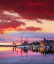 Bergen Harbor With Boats Against Colorful Sunset In Norway, UNESCO World Heritage Site