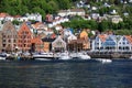 BERGEN HARBOR, NORWAY - MAY 27, 2017: Private boats on a row along the pier and crusskip a sunny day in May.