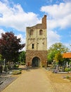Idyllic dutch cemetery with old medieval roman tower, blue sky