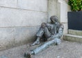 Monument to man at the entrance to the bank.