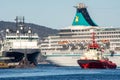 Harbor scene in Bergen, Norway, with cruise ship and towing boat and submarine