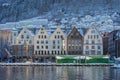 Bergen waterfront cityscape.with pucturesque bryggen houses in light theme in front of the wharf. Looking from across the bay on