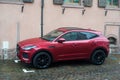 Profile view of red Jaguar E-Pace suv car parked in the street