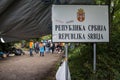 Refugees gathering behing the border sign on Serbia Croatia boundary in Berkasovo Bapska, on Balkans Route, during Refugee Crisis