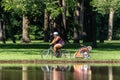 Young Women Riding Bike Pulling Cart Royalty Free Stock Photo