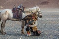 Berkutchi Eagle Hunter with golden eagle during hare hunting.