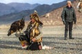 Berkutchi Eagle Hunter with golden eagle during hare hunting