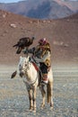 Berkutchi Eagle Hunter with golden eagle during hare hunting.