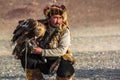 Berkutchi Eagle Hunter with golden eagle during hare hunting.