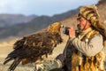 Berkutchi Eagle Hunter while hunting to the hare with a golden eagles on his arms