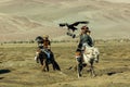 Berkutchi Kazakh Eagle Hunter while hunting to the hare with a golden eagles on his arms Royalty Free Stock Photo