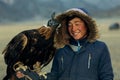 Berkutchi Kazakh Eagle Hunter while hunting to the hare with a golden eagles on his arms Royalty Free Stock Photo