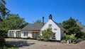 Typical traditional dutch white idyllic country home house in small countryside village