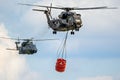 German Air Force NH90 and CH-53 Stallion helicopter with a bambi-bucket Royalty Free Stock Photo