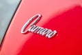Berlin - August 2022: red vintage retro oldtimer Chevrolet Camaro SS 350 side chrome emblem sign logo badge close up
