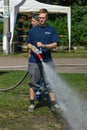 The Berlin firefighter shows skills of working with fog nozzle.