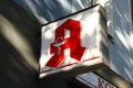 Close up of an Apotheke sign meaning pharmacy / apothecary. Bold, red A on white background. Royalty Free Stock Photo